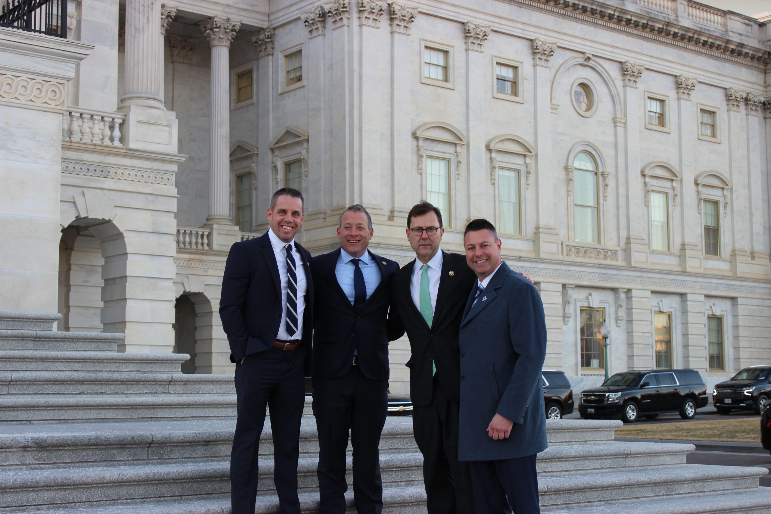 Pictured on the steps of the U.S. Capitol, from left to right: Brian Fitzpatrick, Jr. (SHU '03), Congressman Josh Gottheimer (NJ-05), Congressman Tom Kean, Jr. (NJ-07), and Craig McGraw (SHU '05).